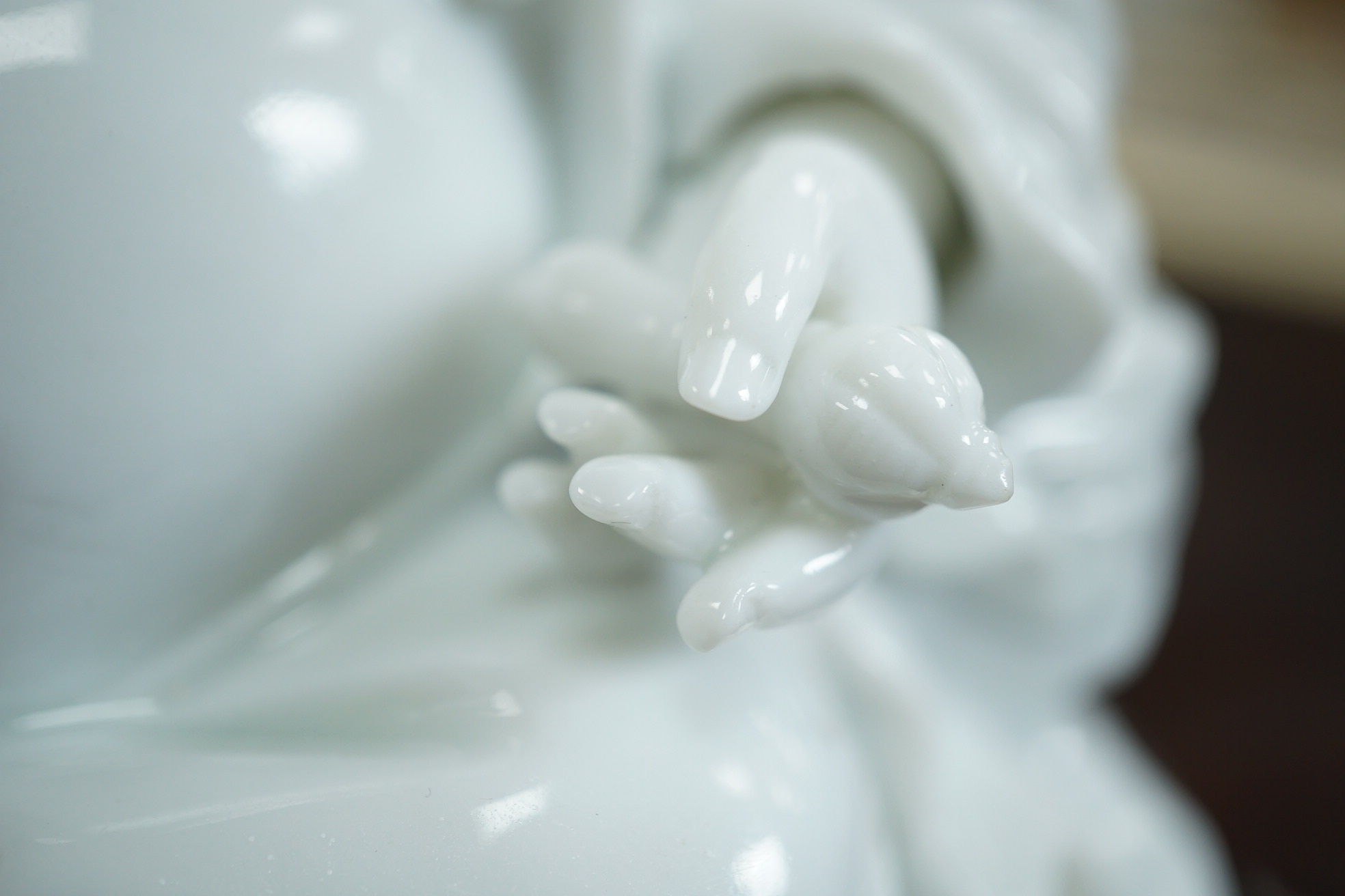 A Chinese blanc-de-chine seated figure of Budai, 18th/19th century